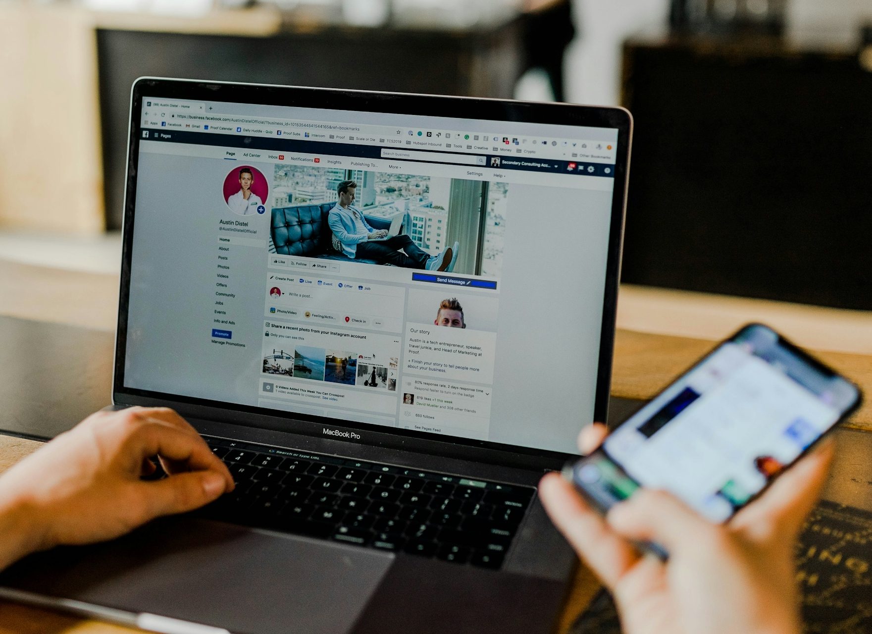 A person using a laptop and a smartphone, viewing social media content.